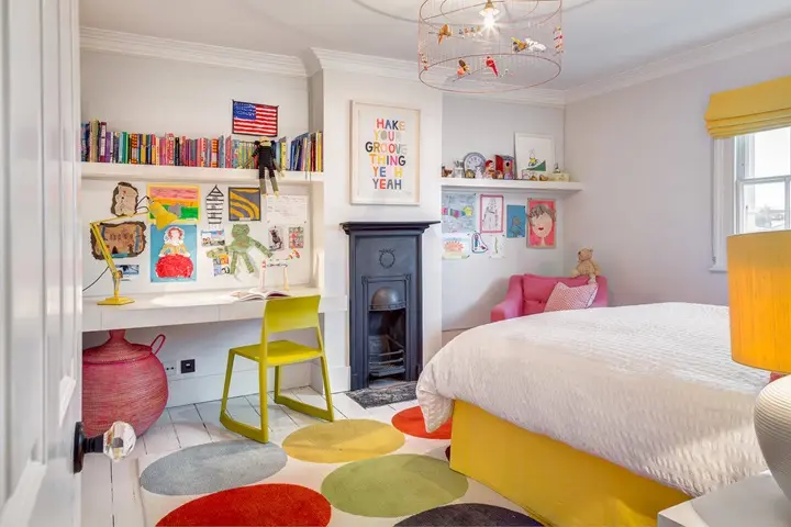 bright and cheerful children’s bedroom featuring white bedding